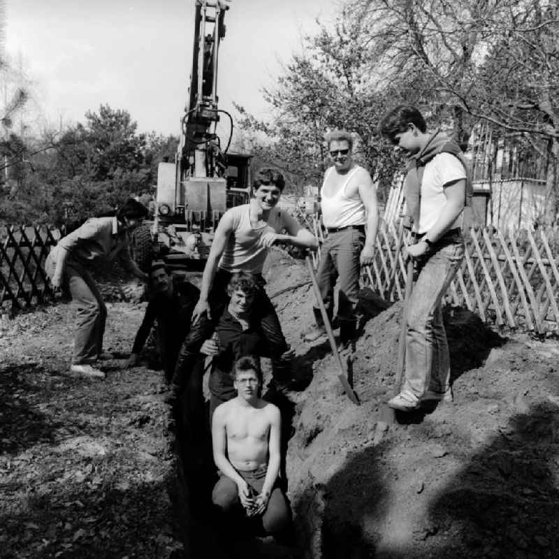 Garden owners and residents dig a cable trench together in Teupitz in the federal state of Brandenburg on the territory of the former GDR, German Democratic Republic