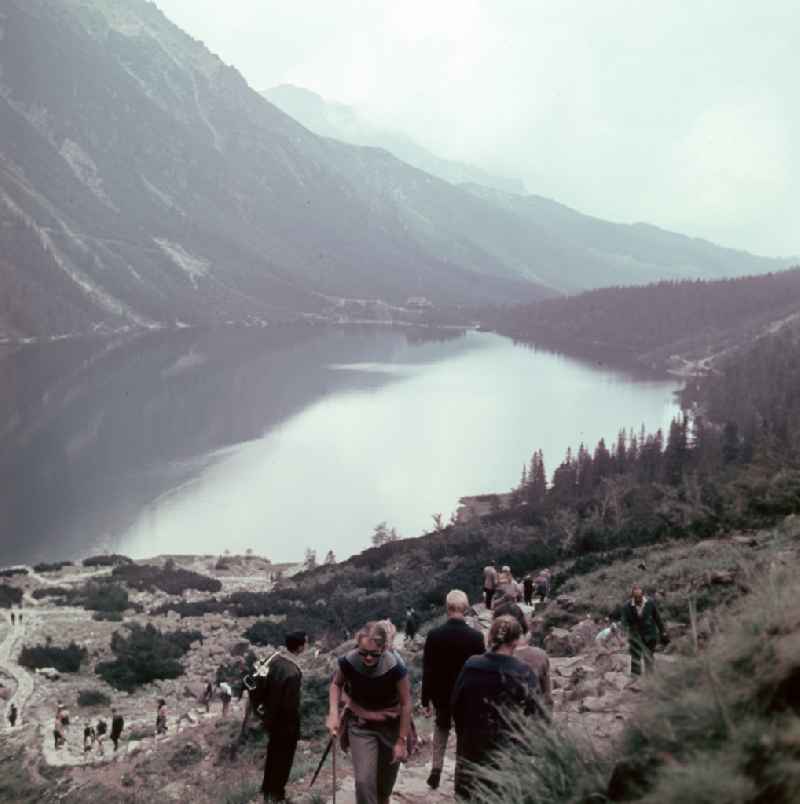 Holidaymakers hiking in the High Tatras at the mountain lake Morskie Oko 'Sea Eye' in Zakopane in Poland