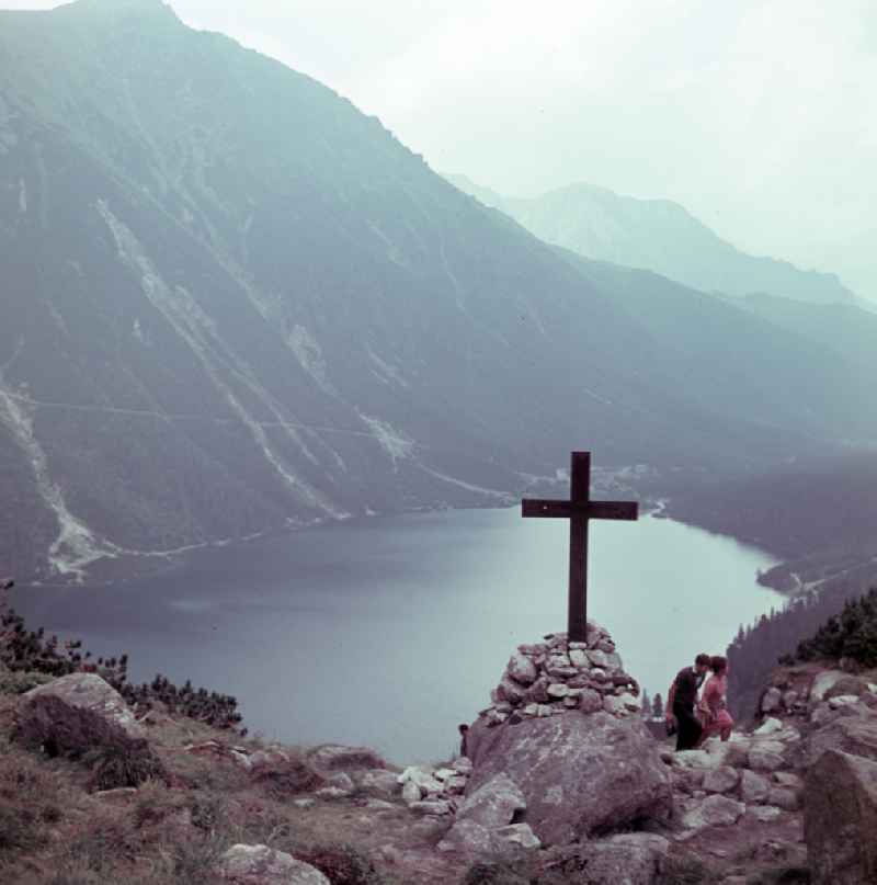 Holidaymakers hiking in the High Tatras at the mountain lake Morskie Oko 'Sea Eye' in Zakopane in Poland