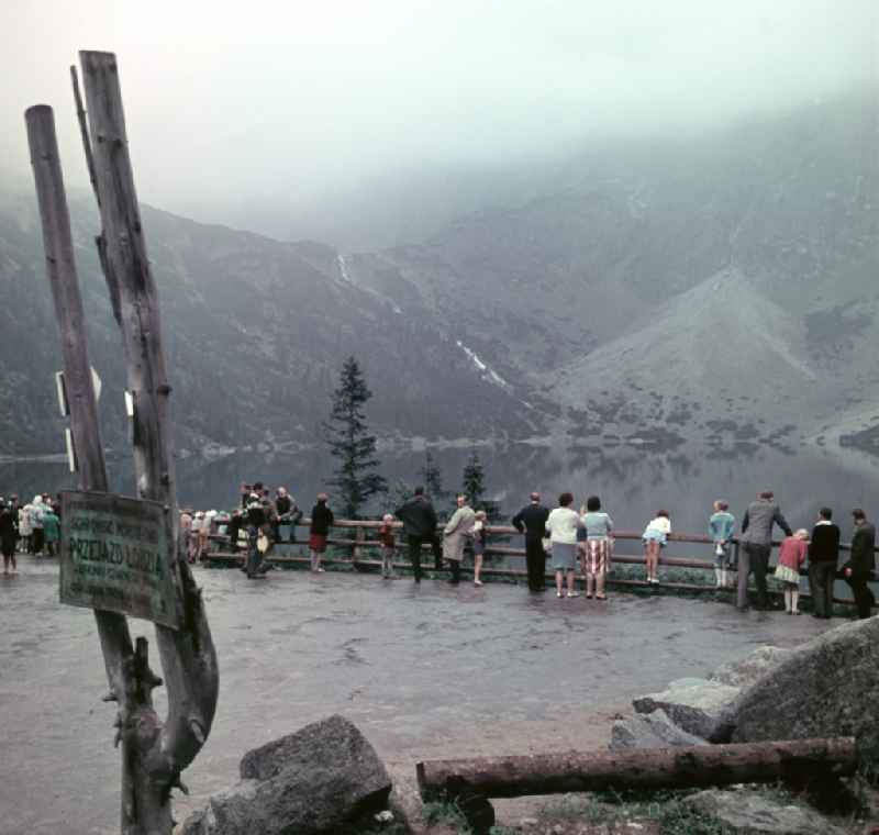 Holidaymakers on an observation deck in the High Tatras at the mountain lake Morskie Oko 'Sea Eye' in Zakopane in Poland